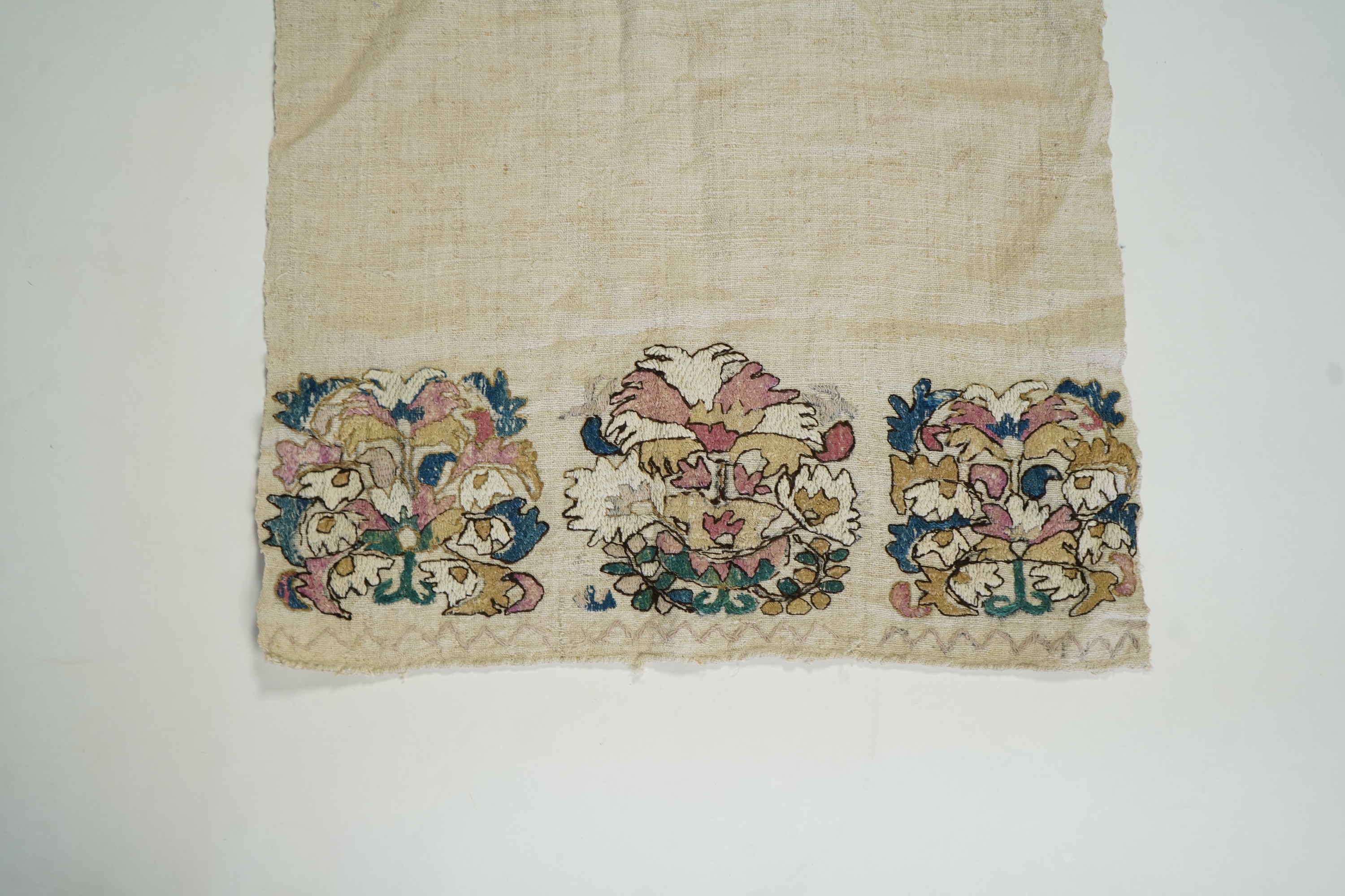 An early 20th century heavy hand woven linen Turkish towel, with coloured silk embroidered ends. 123cm long x 43cm wide. Condition - has two stains and some embroidery worn in places.